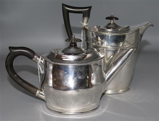 An oval silver teapot, London 1902, and a similar silver coffee pot, Sheffield 1896.